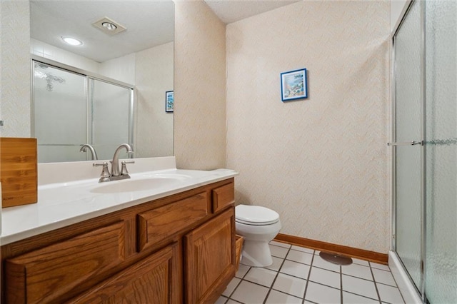 full bath featuring vanity, toilet, tile patterned floors, baseboards, and a shower stall