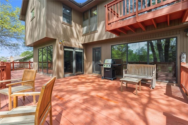 wooden terrace featuring a grill