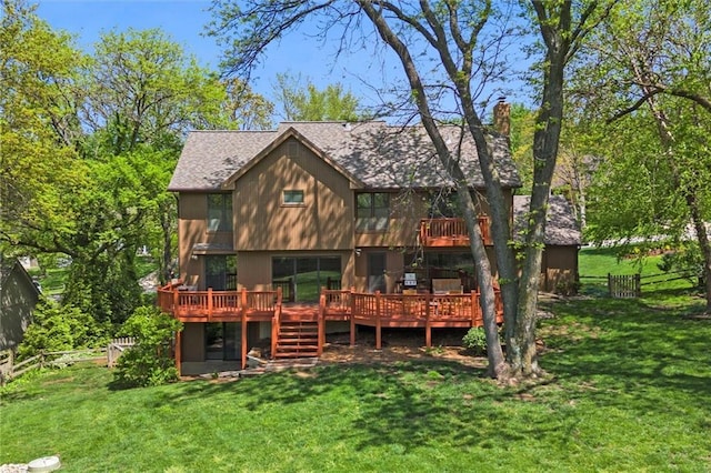 rear view of property featuring a lawn, a wooden deck, a chimney, and fence
