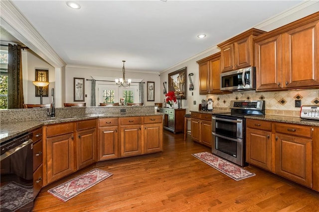 8912 NE 97th St, Kansas City, MO 64157 - kitchen featuring plenty of natural light, a notable chandelier, stainless steel appliances, and a sink