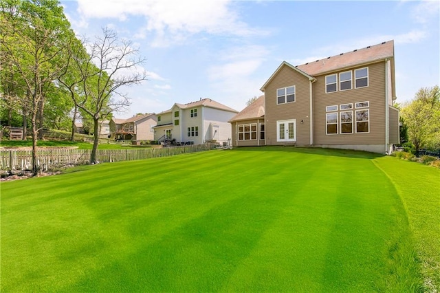 8912 NE 97th St, Kansas City, MO 64157 - back of property featuring a lawn, fence, and french doors