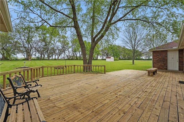 wooden terrace with a yard, an outbuilding, and a shed