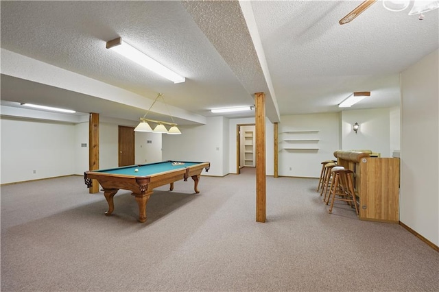 rec room with a textured ceiling, billiards, baseboards, and carpet