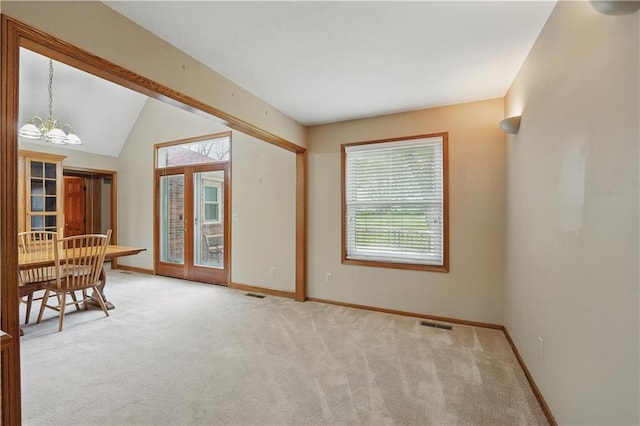 interior space featuring baseboards, plenty of natural light, and carpet