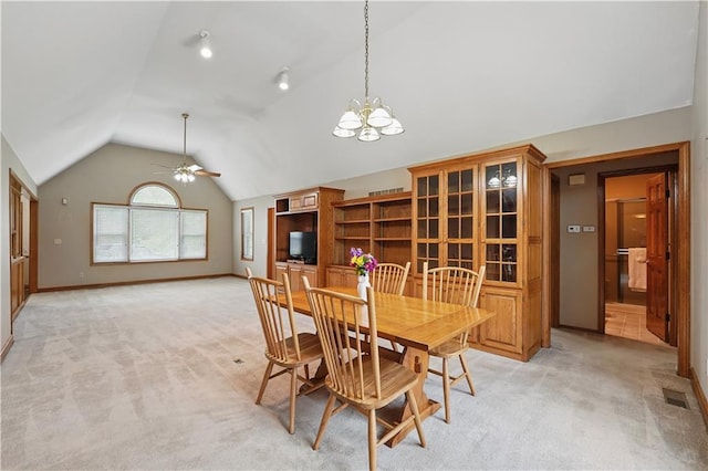 dining area featuring light colored carpet, visible vents, ceiling fan with notable chandelier, baseboards, and vaulted ceiling