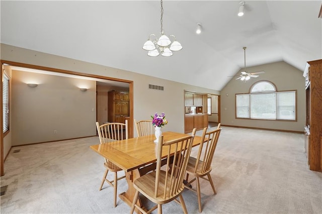dining room with ceiling fan with notable chandelier, light carpet, vaulted ceiling, and visible vents