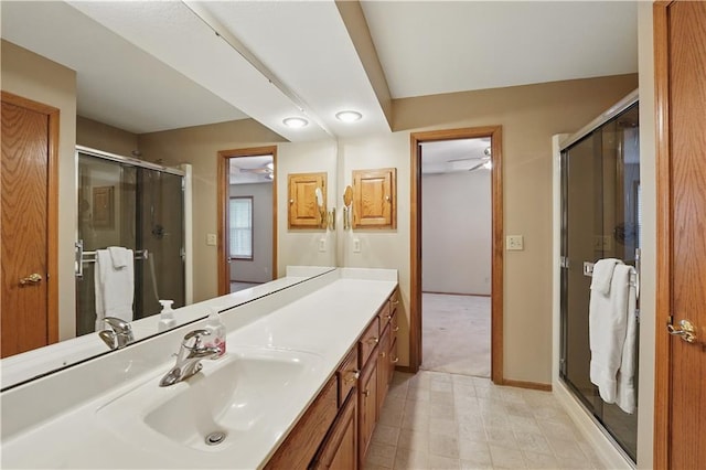 full bathroom with tile patterned floors, a shower stall, baseboards, and vanity