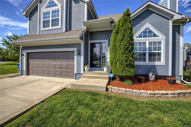 view of front of house with driveway, an attached garage, and a front lawn
