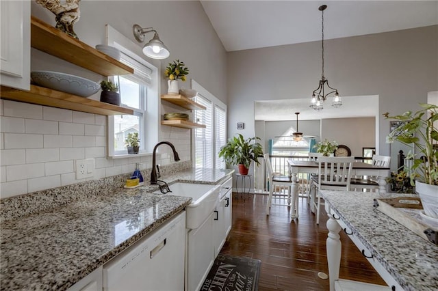 kitchen featuring dishwasher, open shelves, white cabinets, dark wood-style floors, and high vaulted ceiling