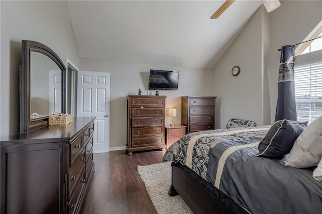 bedroom with vaulted ceiling, dark wood-style flooring, a ceiling fan, and baseboards