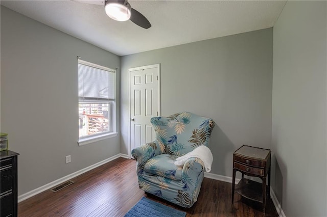 living area featuring a ceiling fan, wood finished floors, and baseboards