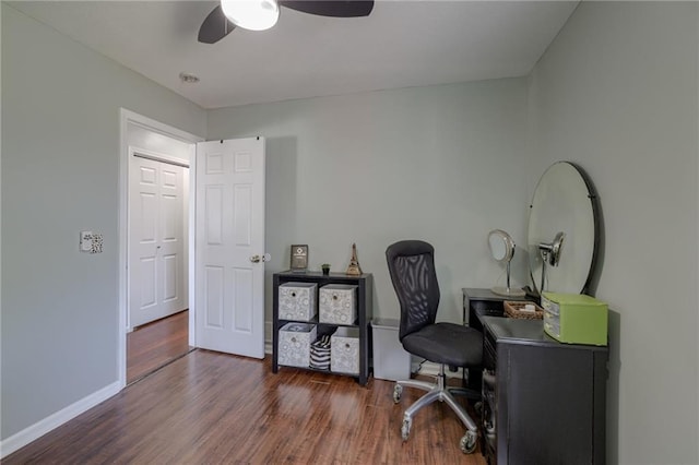 office space with wood finished floors, a ceiling fan, and baseboards