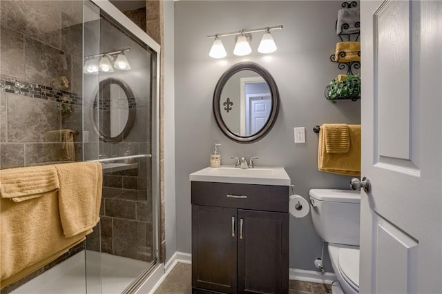 bathroom with baseboards, a shower stall, and toilet