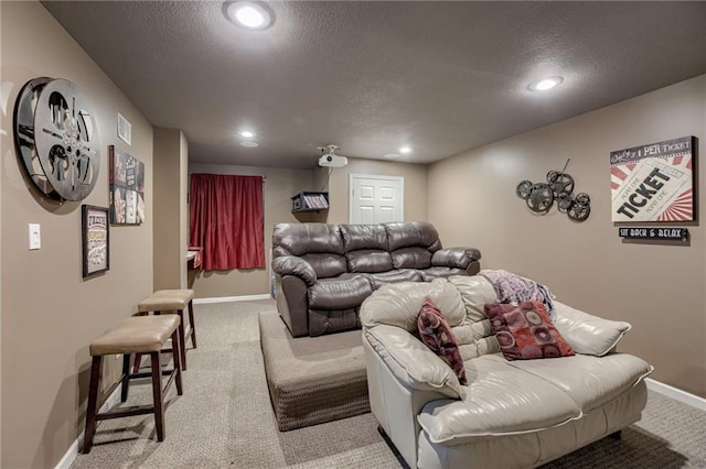 living area featuring carpet floors, baseboards, a textured ceiling, and recessed lighting