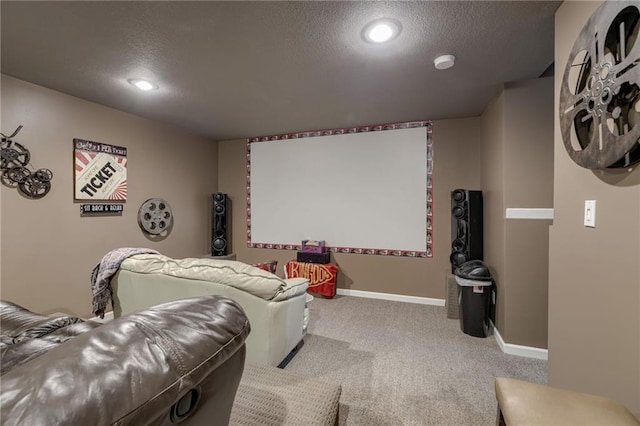 home theater featuring a textured ceiling, carpet flooring, and baseboards