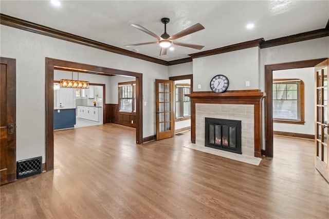5547 Rockhill Rd, Kansas City, MO 64110 - unfurnished living room with a ceiling fan, wood finished floors, and crown molding
