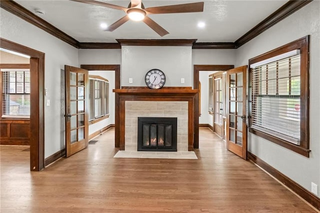 5547 Rockhill Rd, Kansas City, MO 64110 - unfurnished living room with wood finished floors, a ceiling fan, ornamental molding, french doors, and baseboards