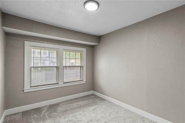 5547 Rockhill Rd, Kansas City, MO 64110 - unfurnished room featuring baseboards and carpet floors