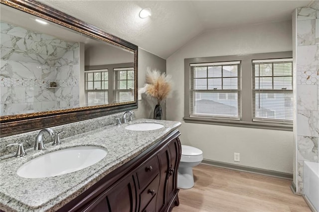 5547 Rockhill Rd, Kansas City, MO 64110 - full bath featuring wood finished floors, lofted ceiling, a shower, and a sink