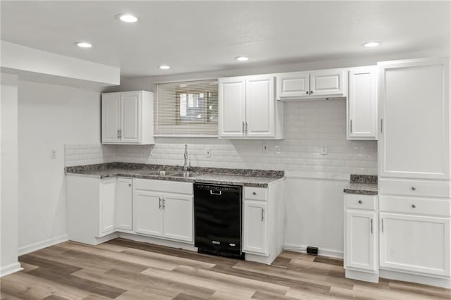 5547 Rockhill Rd, Kansas City, MO 64110 - kitchen featuring backsplash, dishwasher, white cabinetry, and a sink
