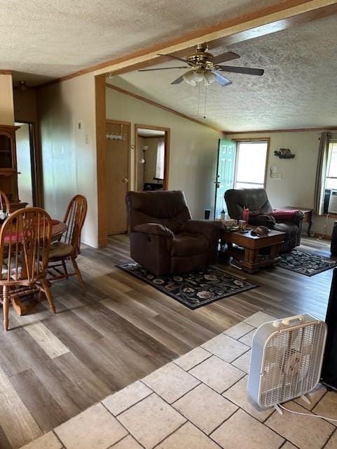 4323 NW County Road 17402nd St, Adrian, MO 64720 - living room featuring a textured ceiling, light wood-type flooring, lofted ceiling, ceiling fan, and crown molding