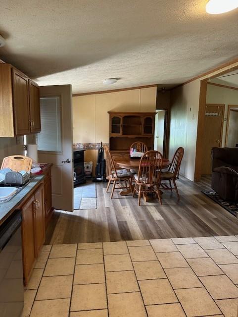 4323 NW County Road 17402nd St, Adrian, MO 64720 - dining room with a textured ceiling, light wood finished floors, and crown molding