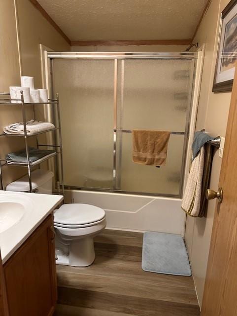 4323 NW County Road 17402nd St, Adrian, MO 64720 - full bath featuring vanity, wood finished floors, toilet, combined bath / shower with glass door, and a textured ceiling