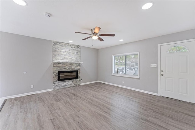 709 W 28th St N, Independence, MO 64050 - unfurnished living room with recessed lighting, wood finished floors, baseboards, a fireplace, and ceiling fan