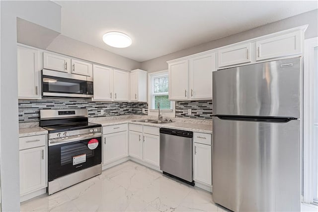 709 W 28th St N, Independence, MO 64050 - kitchen with a sink, marble finish floor, light countertops, white cabinets, and appliances with stainless steel finishes