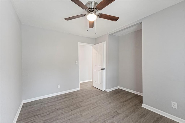 709 W 28th St N, Independence, MO 64050 - empty room featuring wood finished floors, a ceiling fan, and baseboards