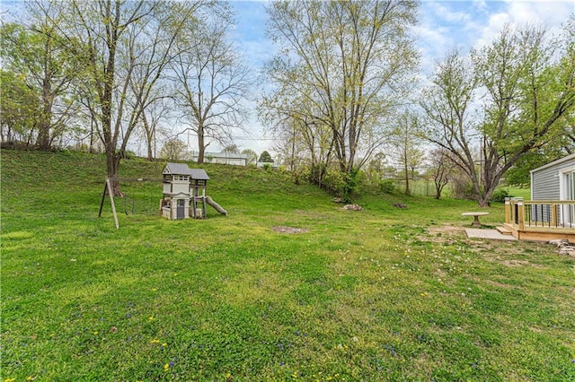 709 W 28th St N, Independence, MO 64050 - view of yard featuring a wooden deck and a playground