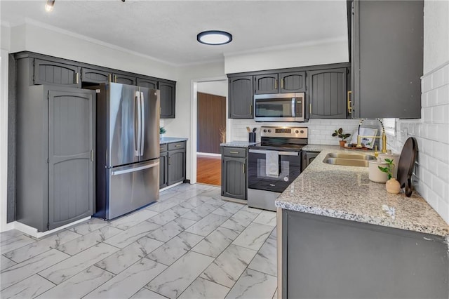 kitchen featuring tasteful backsplash, stainless steel appliances, crown molding, and marble finish floor