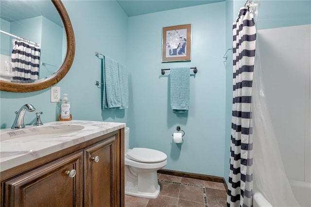 full bath featuring baseboards, vanity, and toilet