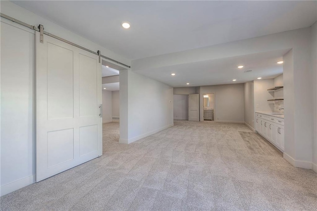 18670 W 248th St, Paola, KS 66071 - below grade area with a barn door, light carpet, baseboards, and recessed lighting