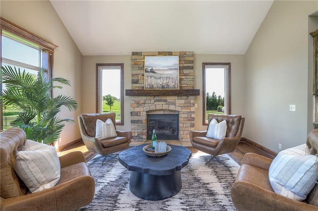 18670 W 248th St, Paola, KS 66071 - living room with vaulted ceiling, baseboards, wood finished floors, plenty of natural light, and a fireplace