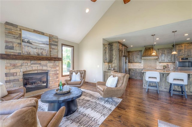 18670 W 248th St, Paola, KS 66071 - living area featuring dark wood finished floors, high vaulted ceiling, a fireplace, recessed lighting, and baseboards