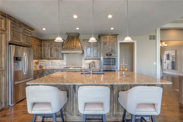18670 W 248th St, Paola, KS 66071 - kitchen with appliances with stainless steel finishes, a sink, premium range hood, recessed lighting, and decorative backsplash