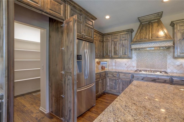 18670 W 248th St, Paola, KS 66071 - kitchen with stainless steel appliances, custom exhaust hood, dark wood finished floors, decorative backsplash, and recessed lighting