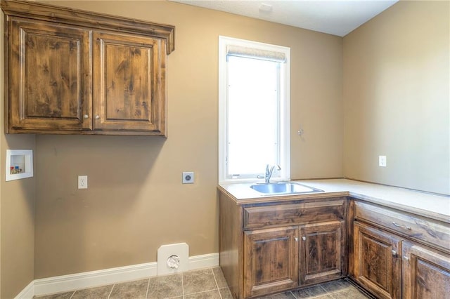 18670 W 248th St, Paola, KS 66071 - laundry area with electric dryer hookup, washer hookup, cabinet space, baseboards, and tile patterned flooring