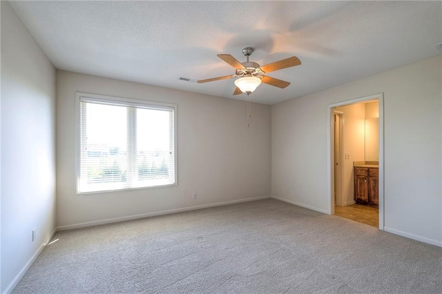 18670 W 248th St, Paola, KS 66071 - unfurnished bedroom with carpet, baseboards, ensuite bath, and a ceiling fan