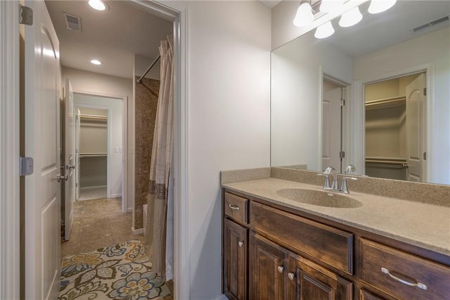 18670 W 248th St, Paola, KS 66071 - full bath featuring a spacious closet, tile patterned flooring, vanity, recessed lighting, and curtained shower
