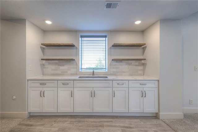 18670 W 248th St, Paola, KS 66071 - kitchen with open shelves, a sink, baseboards, light stone countertops, and recessed lighting