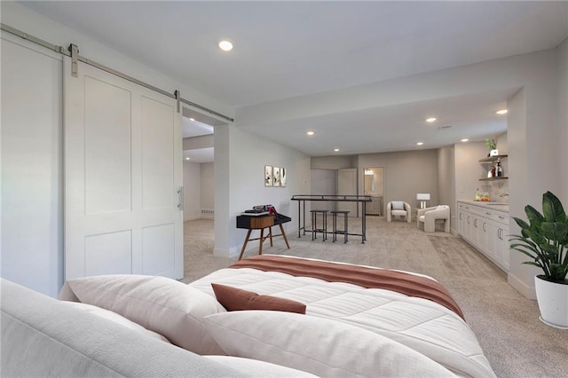 18670 W 248th St, Paola, KS 66071 - living room featuring light colored carpet, a barn door, recessed lighting, and baseboards