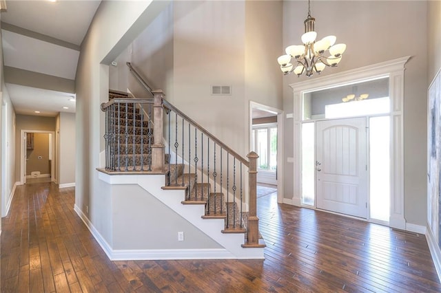 18670 W 248th St, Paola, KS 66071 - entryway featuring a chandelier, hardwood / wood-style flooring, baseboards, stairs, and a high ceiling