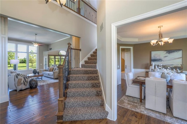 18670 W 248th St, Paola, KS 66071 - stairway featuring ornamental molding, wood-type flooring, a chandelier, and ceiling fan