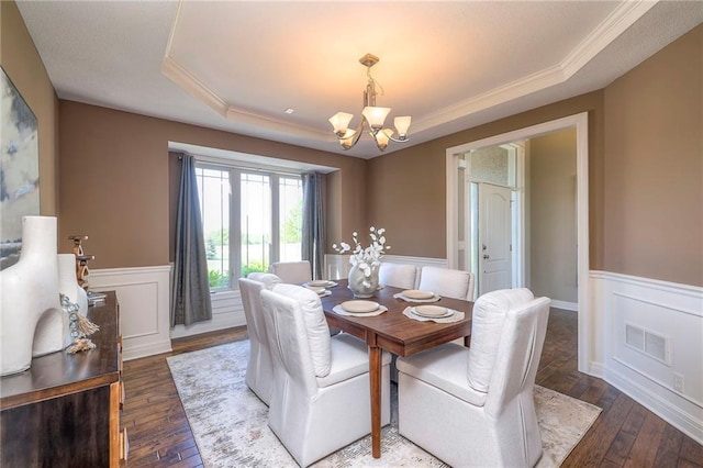 18670 W 248th St, Paola, KS 66071 - dining space featuring a raised ceiling, a chandelier, a wainscoted wall, crown molding, and wood-type flooring