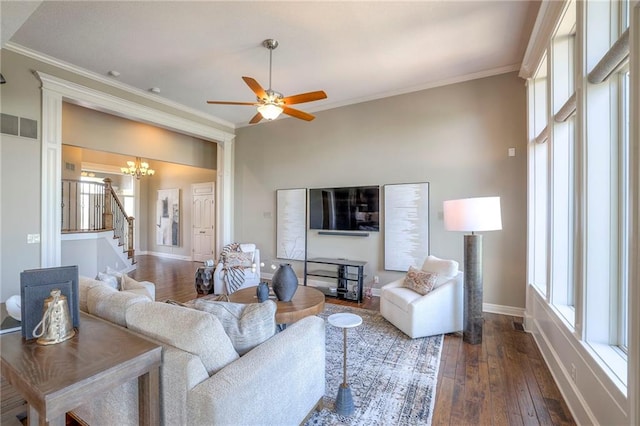 18670 W 248th St, Paola, KS 66071 - living area with stairs, healthy amount of natural light, crown molding, and dark wood-style flooring