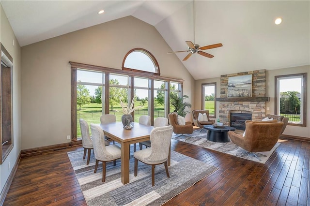 18670 W 248th St, Paola, KS 66071 - dining area with hardwood / wood-style floors, high vaulted ceiling, a stone fireplace, ceiling fan, and baseboards