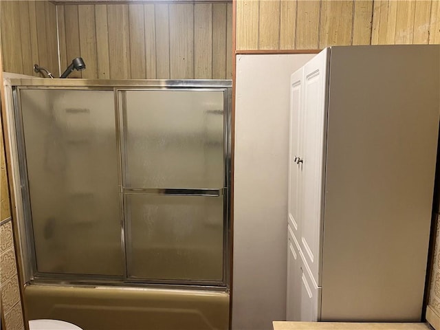 full bathroom featuring bath / shower combo with glass door