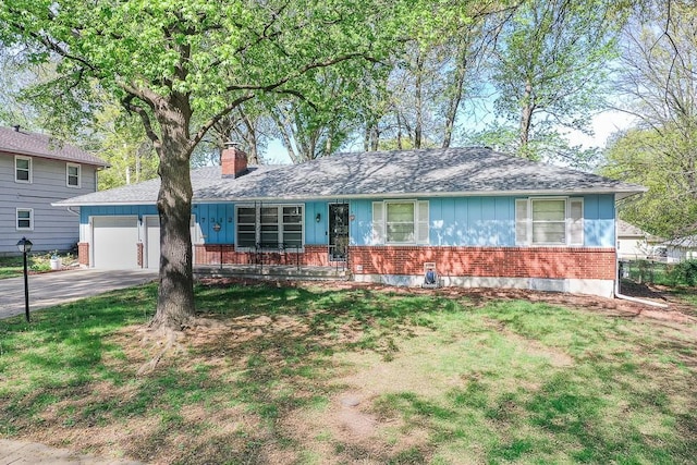 ranch-style home featuring an attached garage, a front lawn, brick siding, and concrete driveway